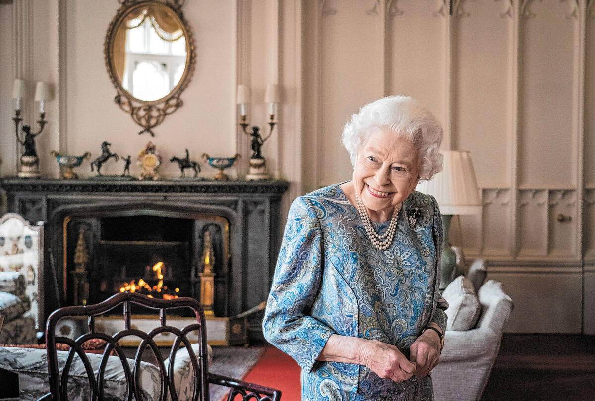 FILE - Britain's Queen Elizabeth II smiles while receiving the President of Switzerland Ignazio ...