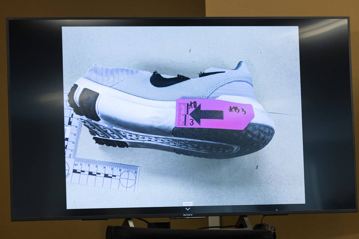 Case evidence is displayed on a screen during a news conference on the arrest of Robert Telles ...