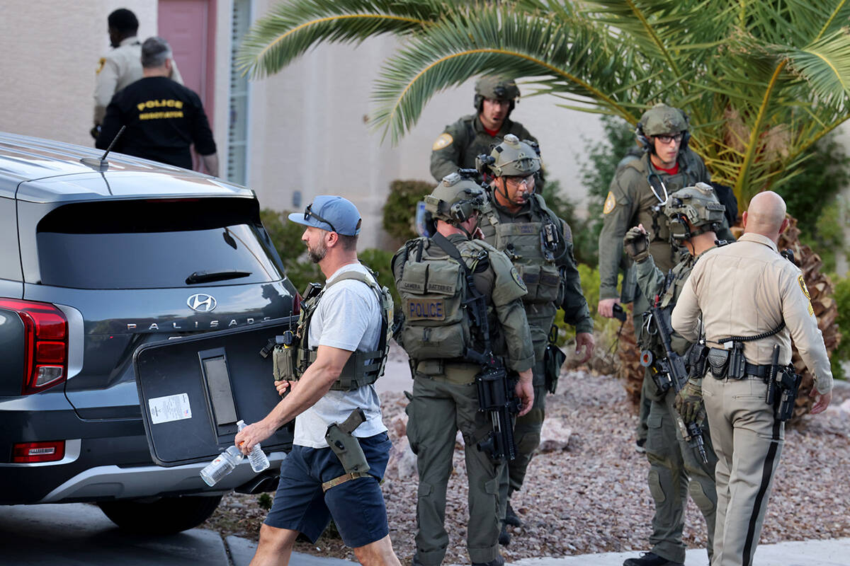 Las Vegas police SWAT officers outside the home of Clark County Public Administrator Robert Tel ...