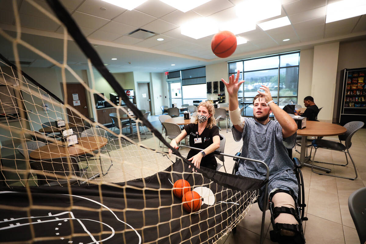 Ashleigh Buccellato, a certified occupational therapist, works with Riley McGowan during a phys ...