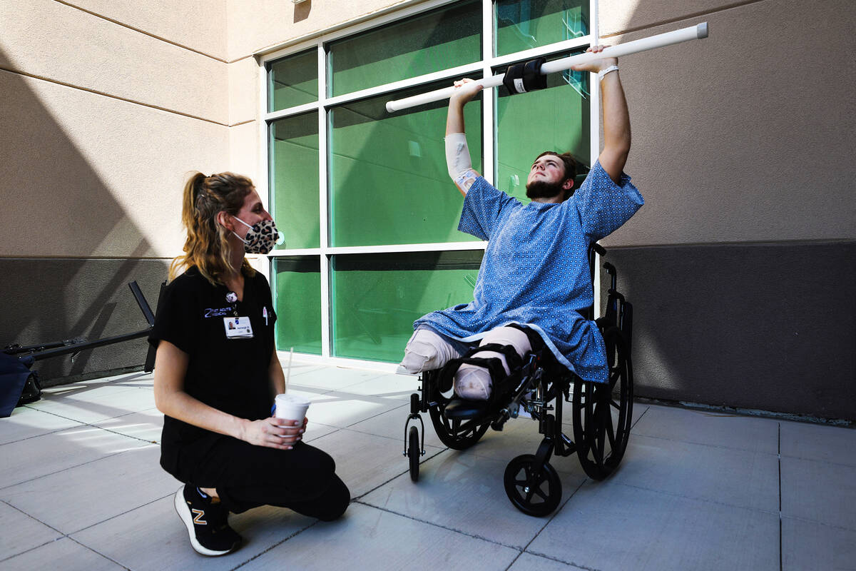 Ashleigh Buccellato, a certified occupational therapist, left, works with Riley McGowan, right, ...