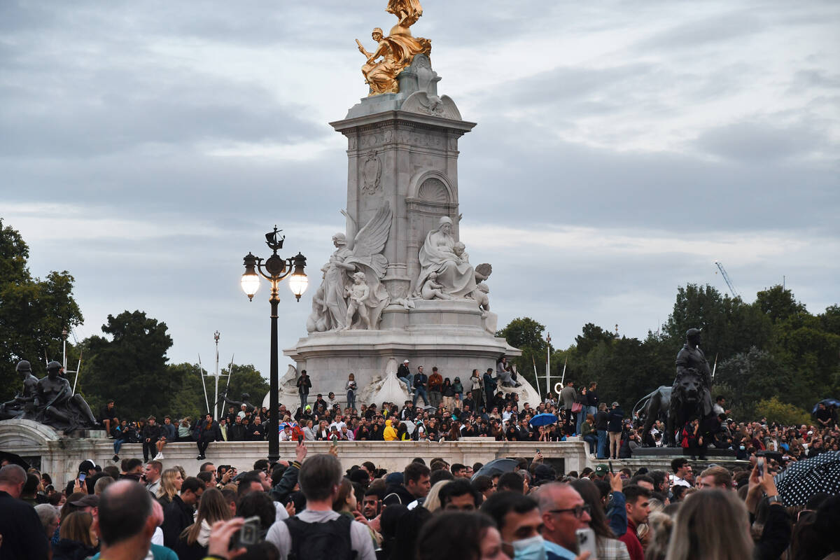 Crowds gathered to pay their respects to Queen Elizabeth II outside Buckingham Palace on Thursd ...
