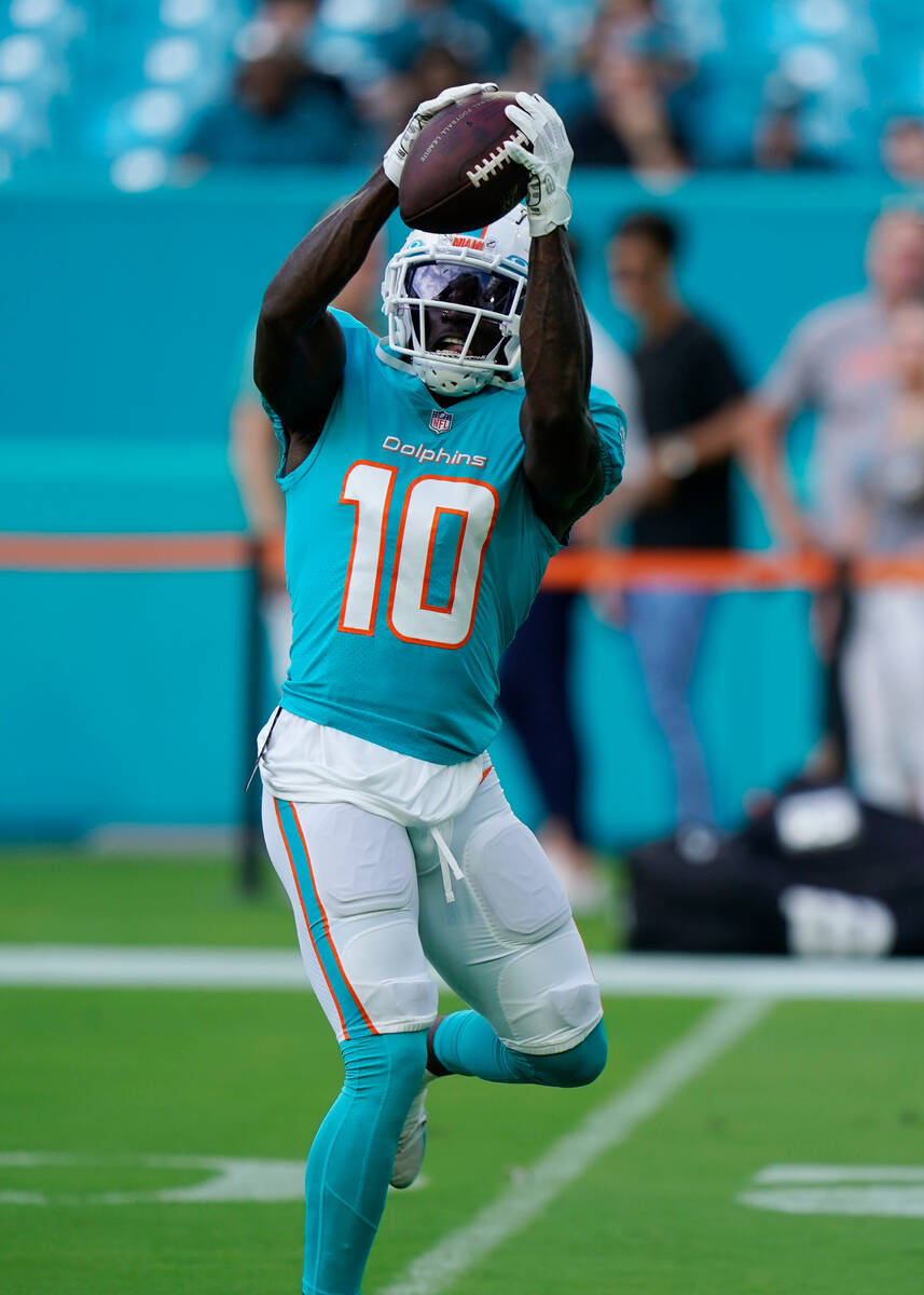 Miami Dolphins wide receiver Tyreek Hill (10) warms up before a NFL preseason football game aga ...