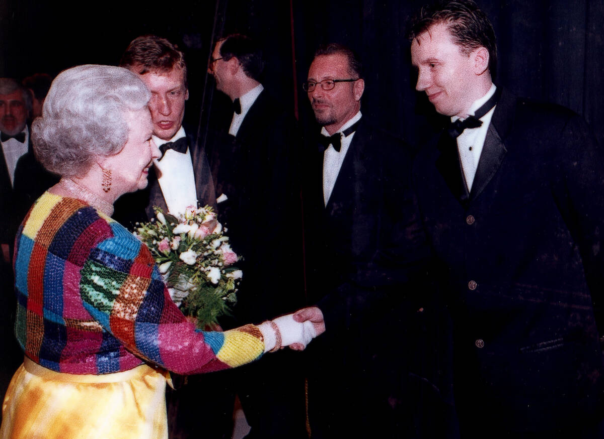 Andy Walmsley is shown meeting Queen Elizabeth II after the 1995 "Royal Variety Show" in London ...