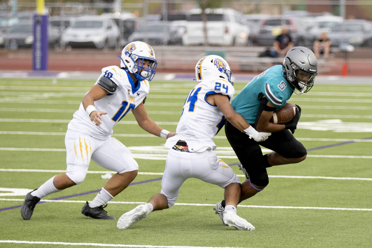 Sierra Vista senior Bryant Wallace (24) tackles Silverado sophomore D'Angelo Hagans (5) during ...