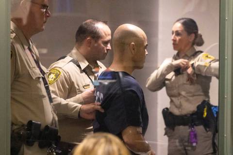 Clark County Public Administrator Robert Telles is led out of the courtroom after his initial c ...