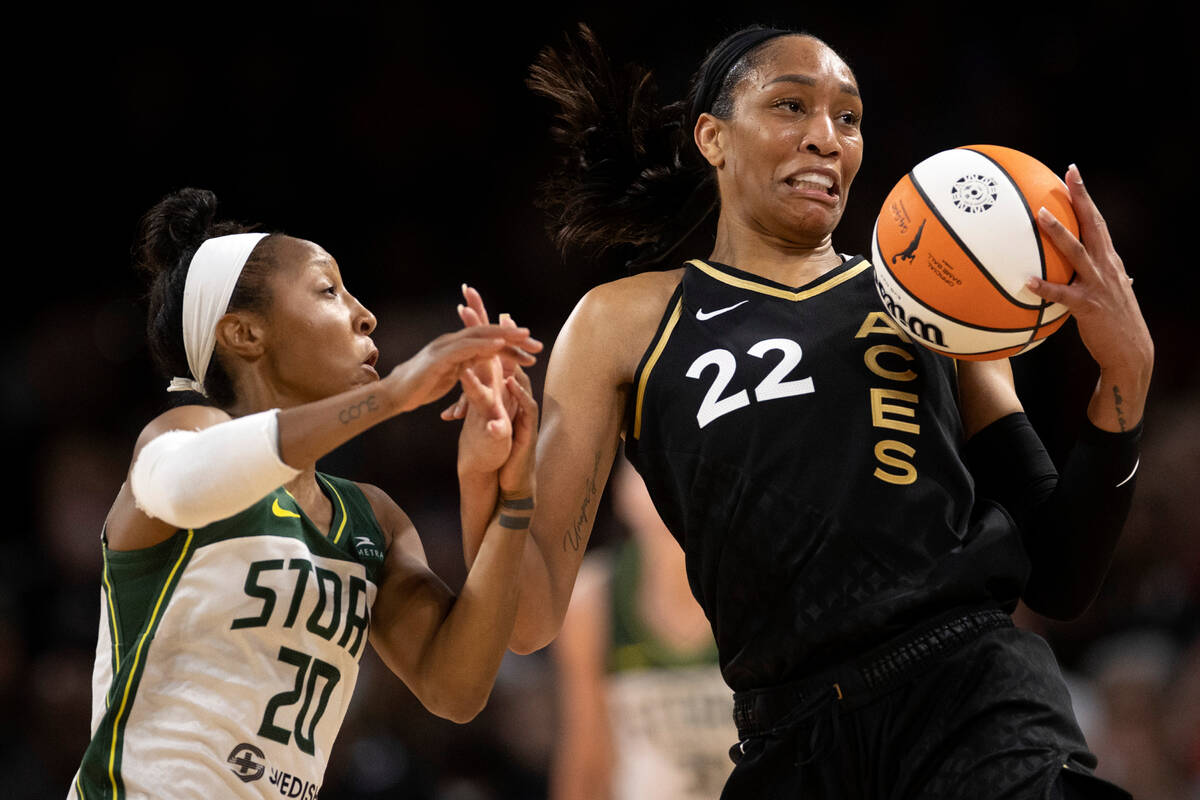 Las Vegas Aces forward A'ja Wilson (22) receives a pass while Seattle Storm guard Briann Januar ...