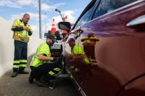 Stephen San Filippo, left, a supervisor Freeway Service Patrol operator, looks on as Tim Stanko ...