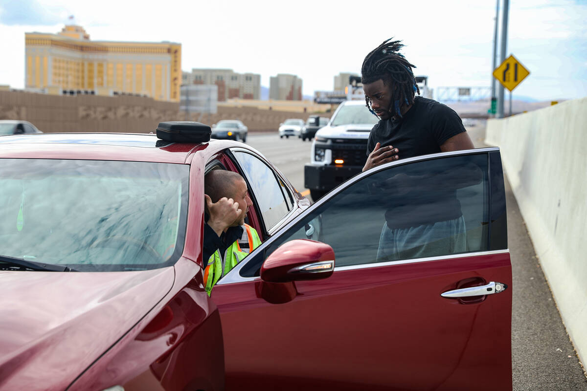 Stephen San Filippo, left, a supervisor Freeway Service Patrol operator, assists Jonathan Bragg ...