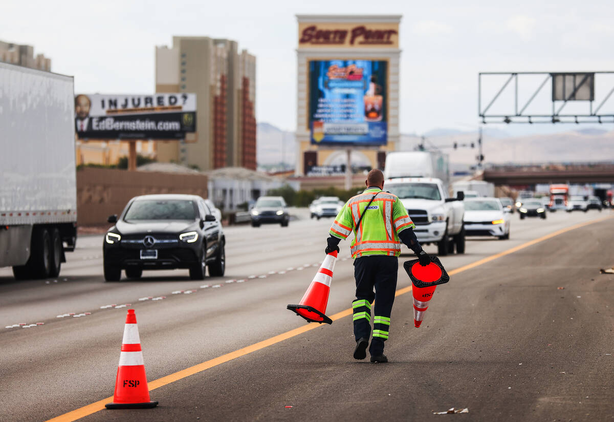 Stephen San Filippo, a supervisor Freeway Service Patrol operator, lays out cones on the I-15 i ...