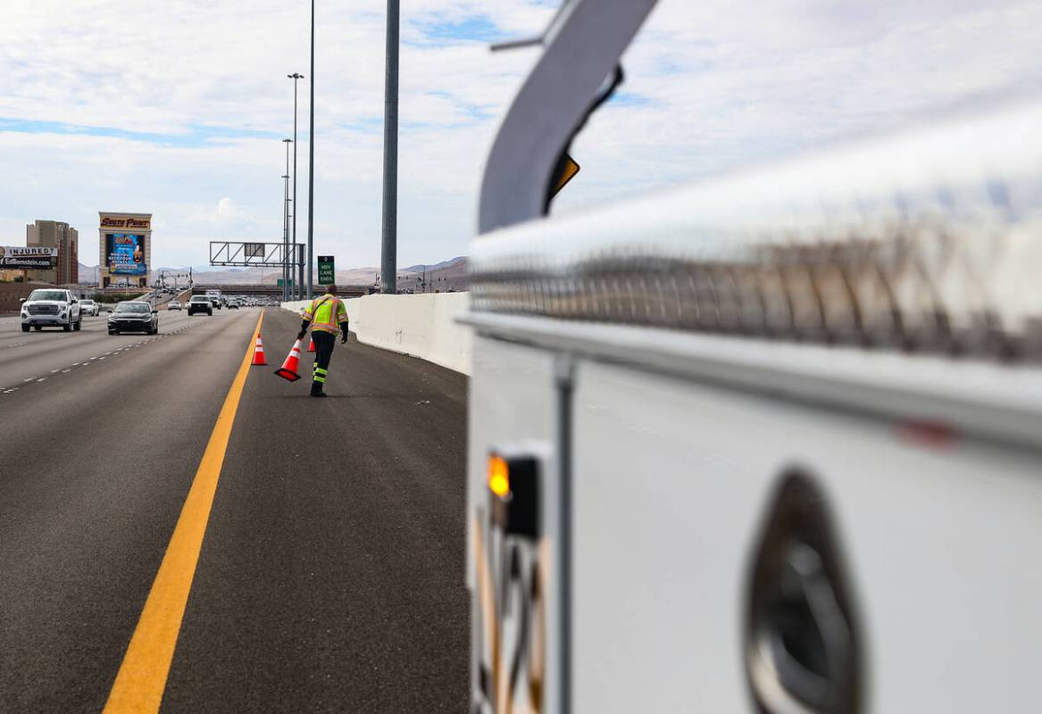 Stephen San Filippo, a supervisor Freeway Service Patrol operator, lays out cones on the I-15 i ...