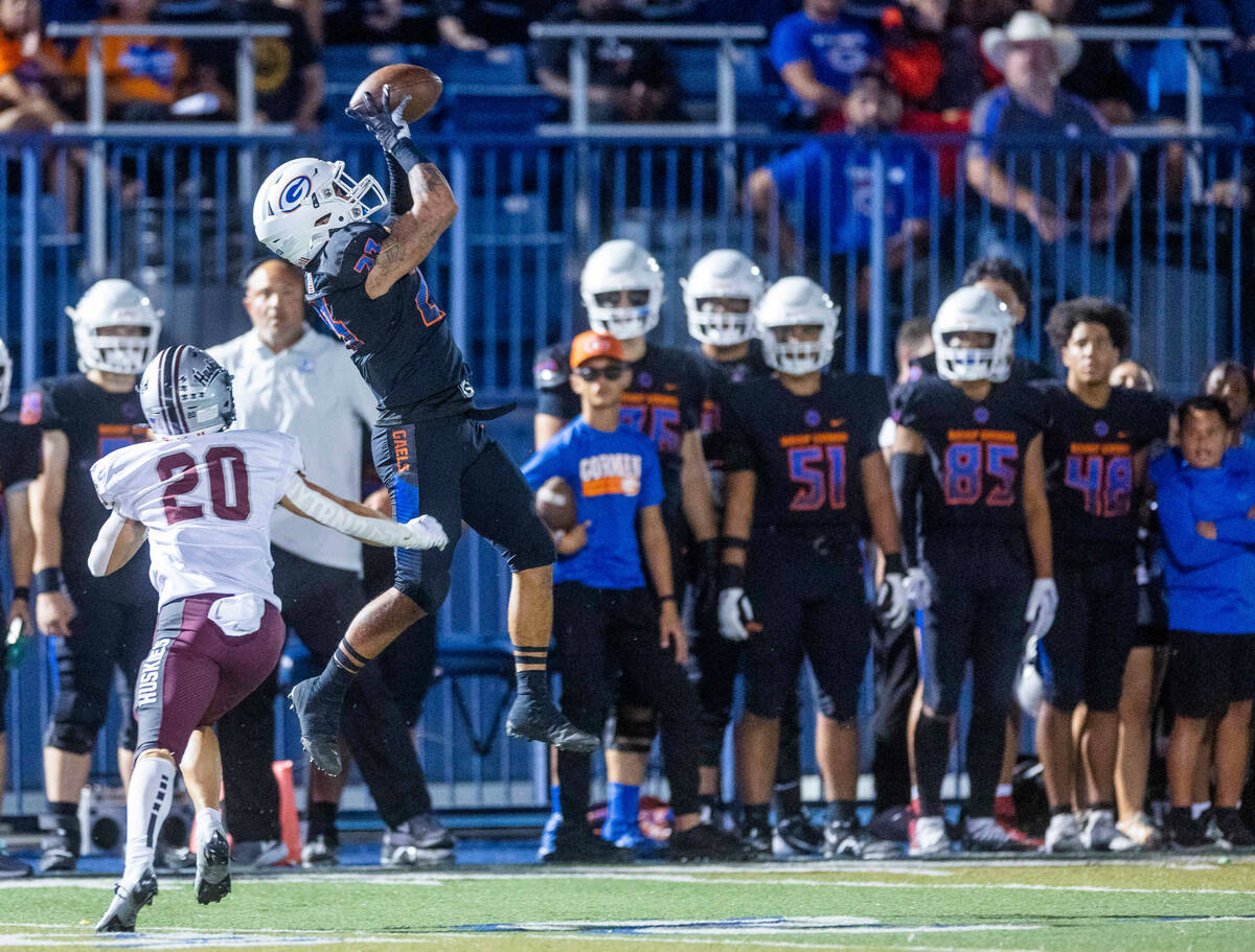 Bishop Gorman wide receiver Trech Kekahuna (23) leaps for a long reception over Hamilton corner ...