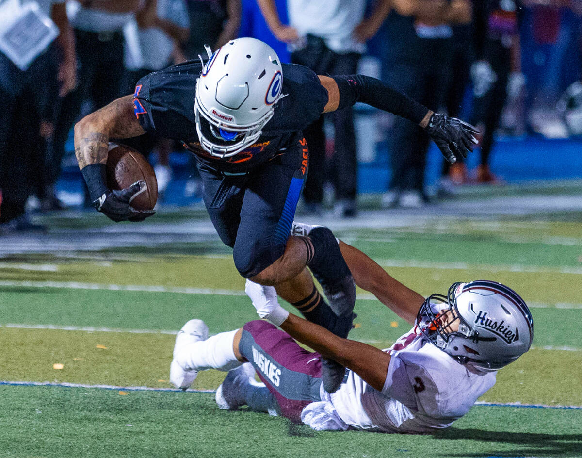 Bishop Gorman wide receiver Trech Kekahuna (23) looks to break a tackle by Hamilton free safety ...