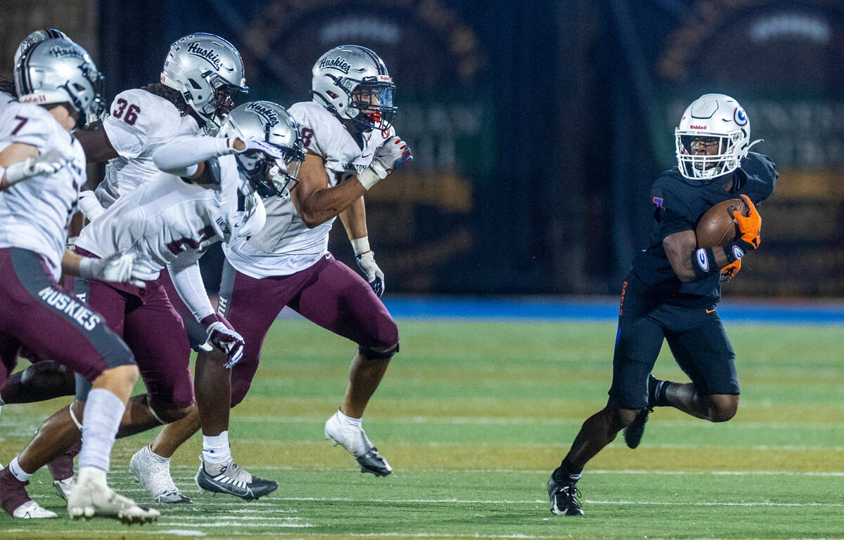 Bishop Gorman running back Devon Rice (3) breaks into open field pursued by Hamilton defenders ...