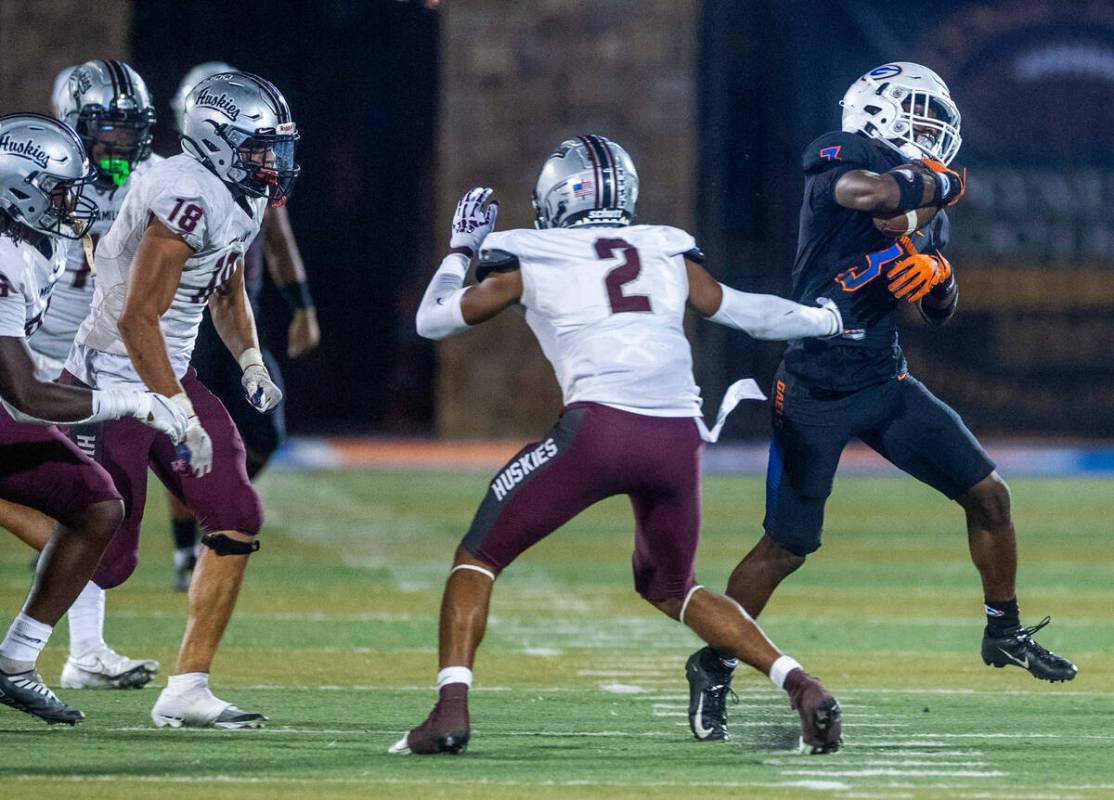 Bishop Gorman running back Devon Rice (3) breaks a tackle attempt by a Hamilton defender during ...