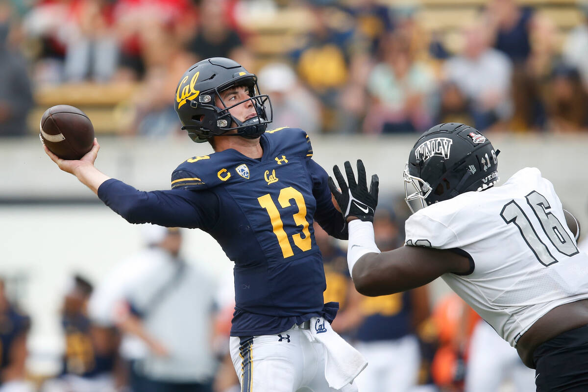 California Golden Bears quarterback Jack Plummer (13) is pressured by UNLV Rebels defensive lin ...