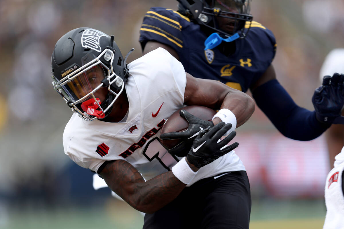 UNLV's Kyle Williams (1) runs for a touchdown against California during the first half of an NC ...