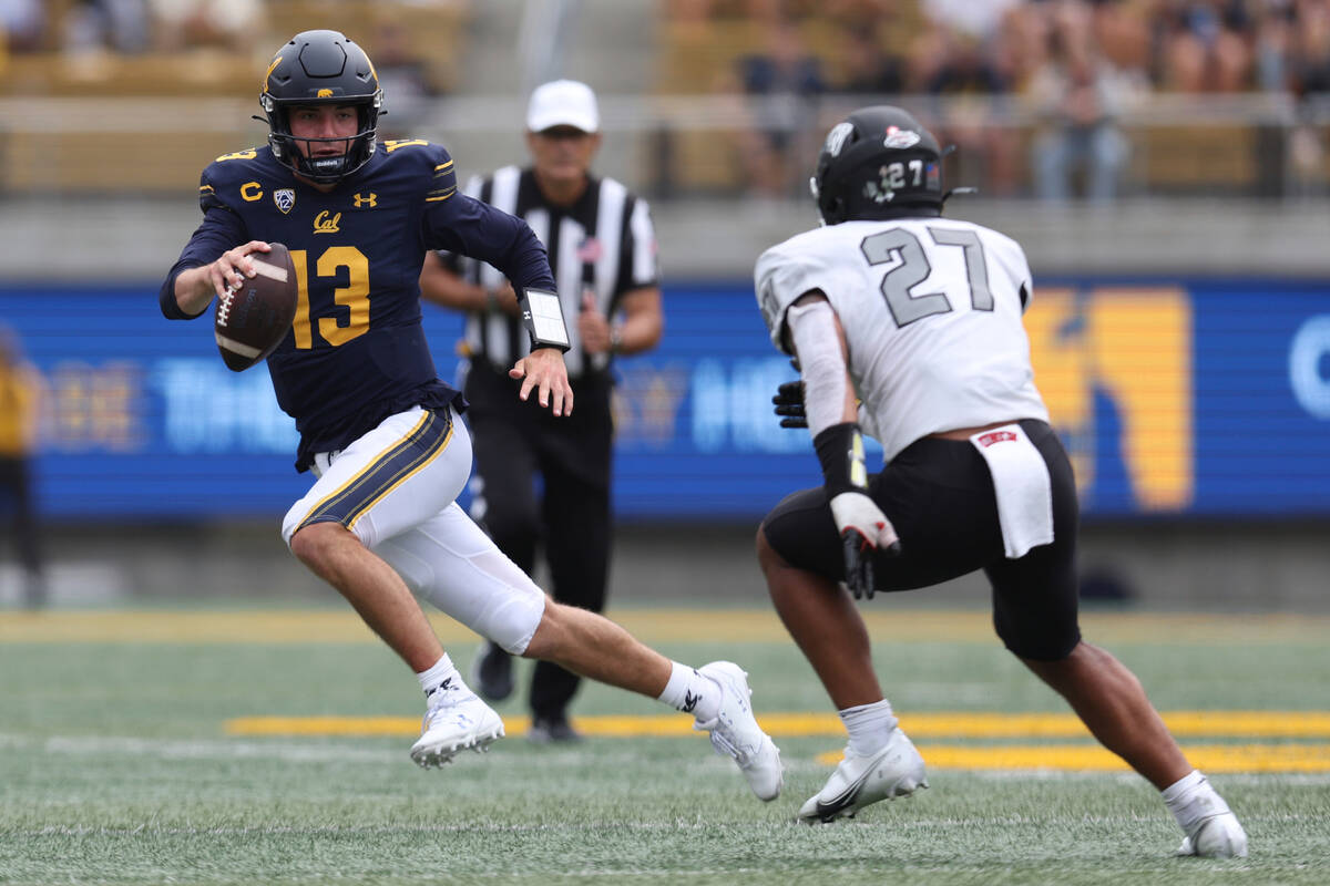 California quarterback Jack Plummer (13) runs against UNLV linebacker Austin Ajiake (27) during ...