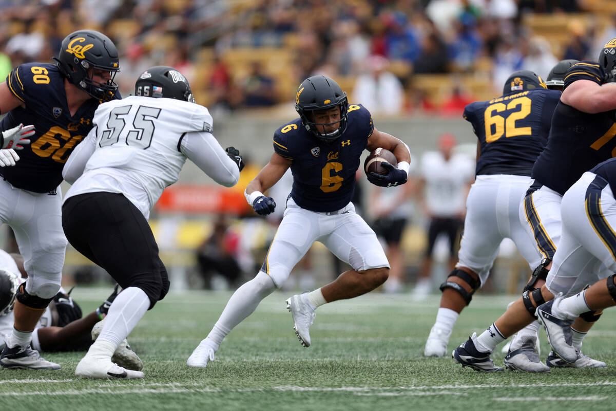 California running back Jaydn Ott (6) runs against UNLV defensive lineman Tavis Malakius (55) d ...