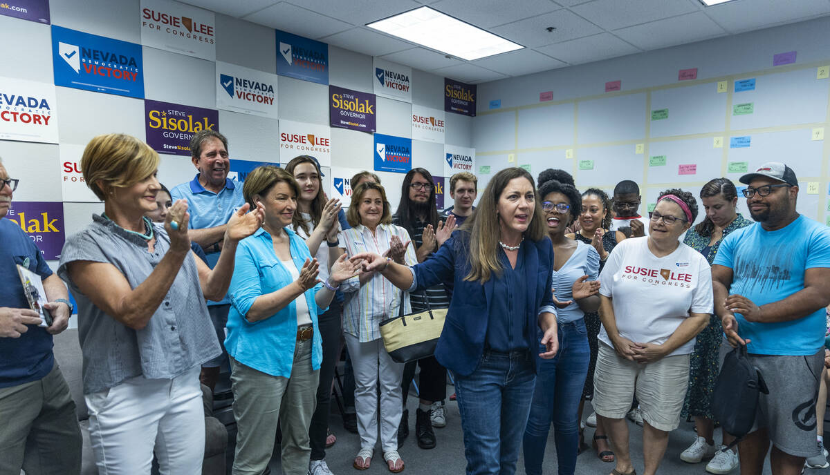 President Tiffany Muller with End Citizens United, center, speaks beside Senator Amy Klobuchar, ...