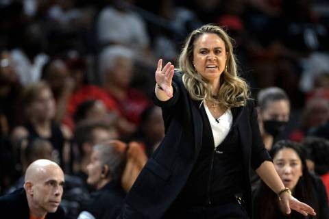 Las Vegas Aces head coach Becky Hammon signals to her team from the sidelines during the first ...