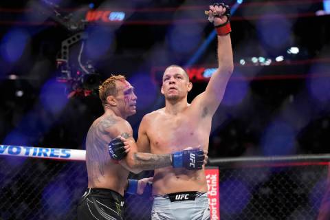Nate Diaz, right, celebrates after defeating Tony Ferguson in a welterweight bout during the UF ...