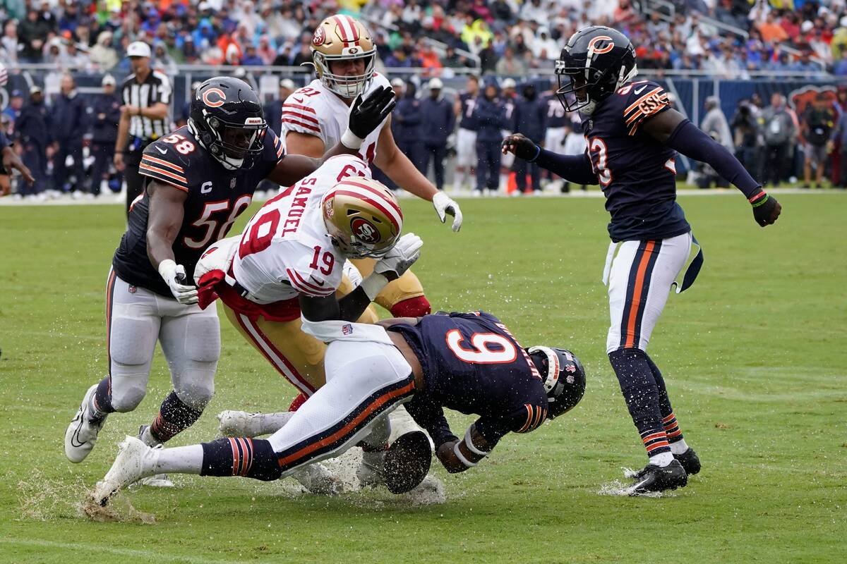 Chicago Bears' Jaquan Brisker hits San Francisco 49ers' Deebo Samuel as he fumbles during the f ...