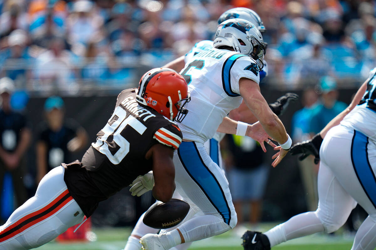 Carolina Panthers quarterback Baker Mayfield is sacked by Cleveland Browns defensive end Myles ...
