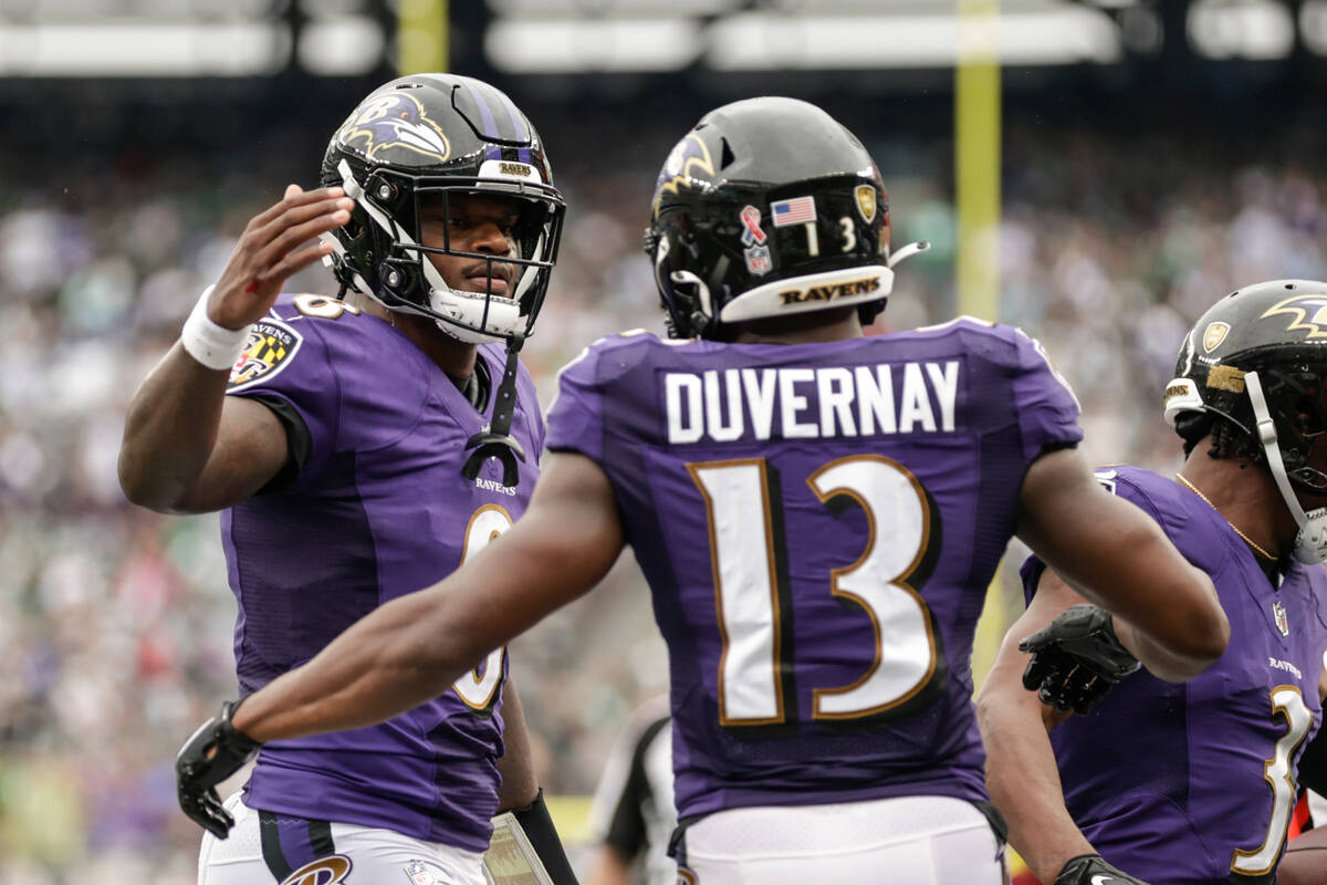 Baltimore Ravens quarterback Lamar Jackson, left, celebrates with Devin Duvernay after they con ...