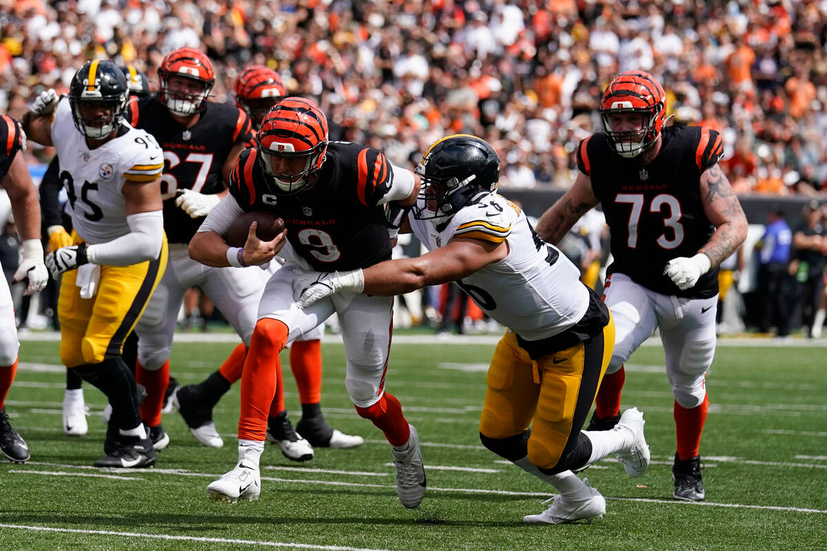 Cincinnati Bengals quarterback Joe Burrow (9) is tackled by Pittsburgh Steelers linebacker Alex ...