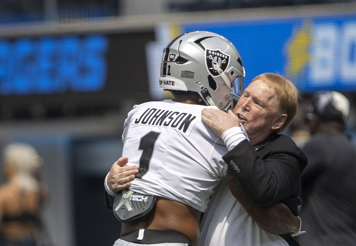 Raiders wide receiver Tyron Johnson (1) hugs owner Mark Davis before an NFL game against the Lo ...