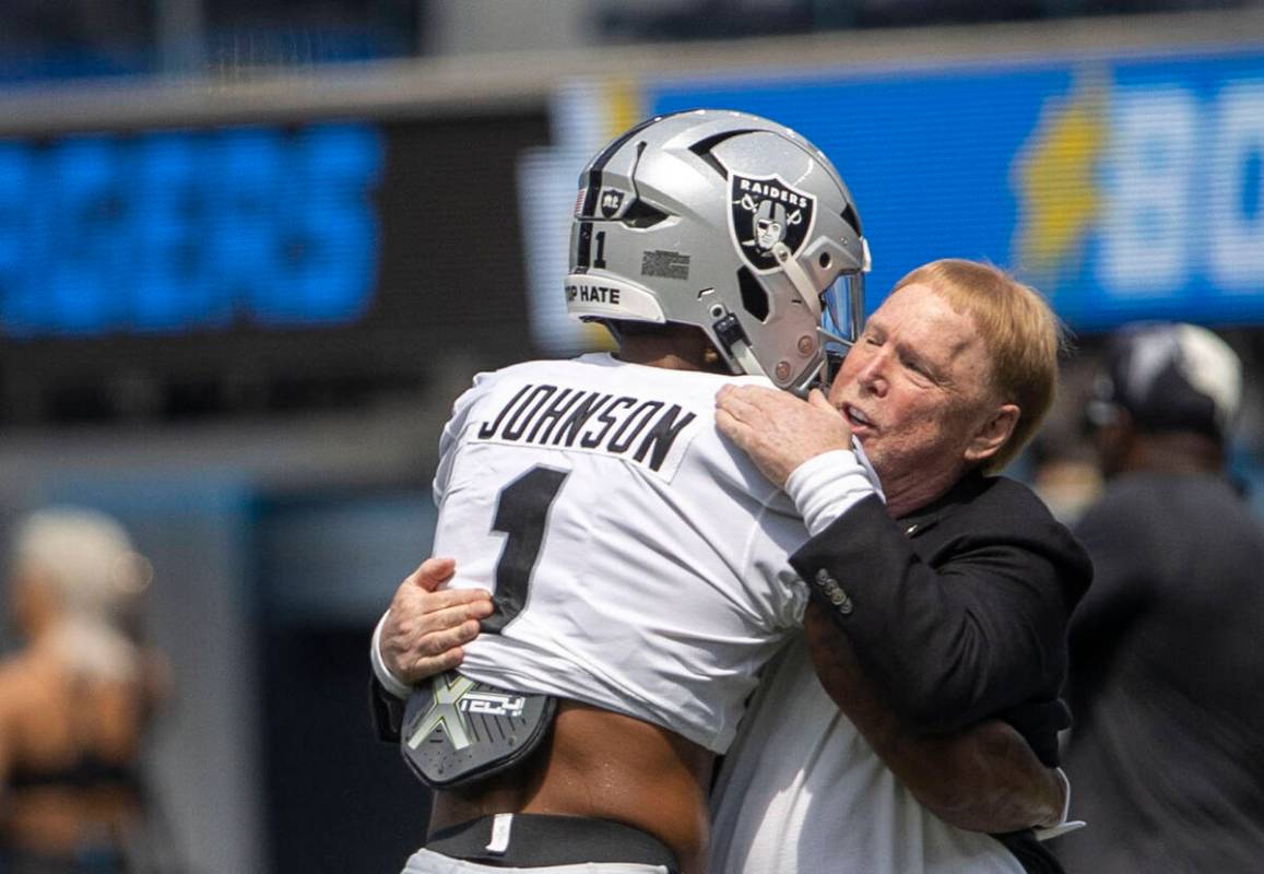 Raiders wide receiver Tyron Johnson (1) hugs owner Mark Davis before an NFL game against the Lo ...