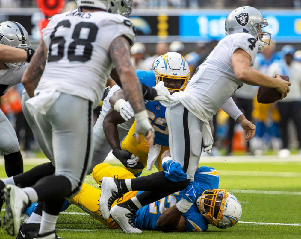 Los Angeles Chargers linebacker Khalil Mack (52) and linebacker Ty Shelby (59) sack Raiders qua ...