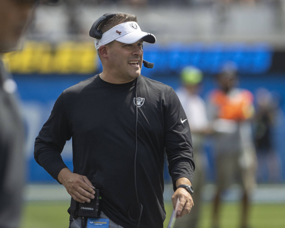 Raiders head coach Josh McDaniels walks the sideline during the first half of an NFL game again ...