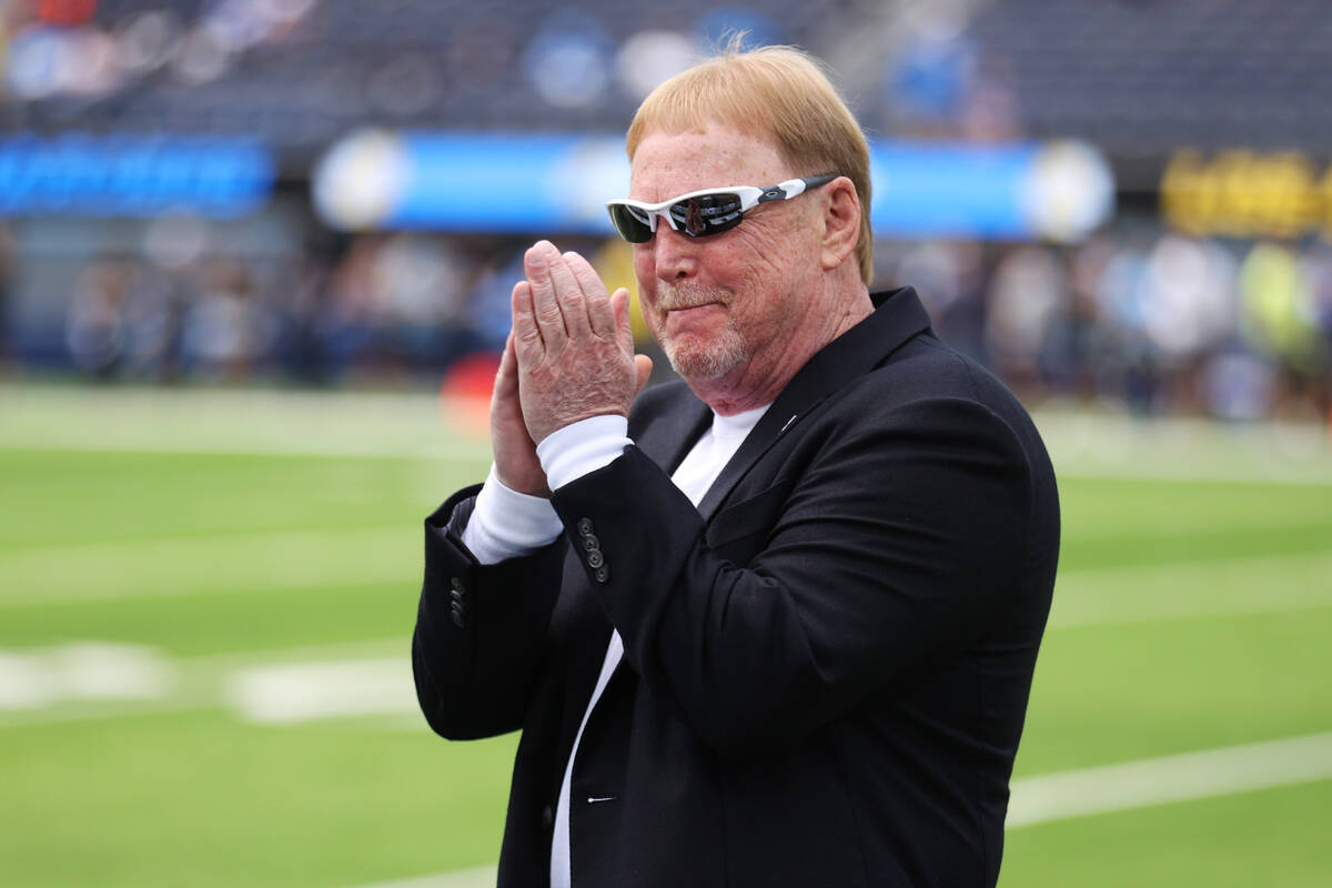 Raiders owner MarK Davis takes the field before the start of an NFL football game between the R ...