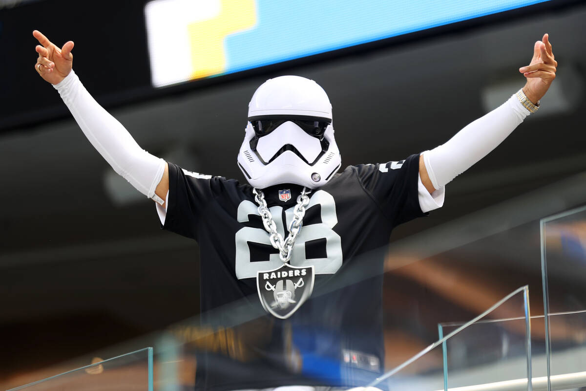 A fan poses before the start of an NFL football game between the Raiders and the Los Angeles Ch ...