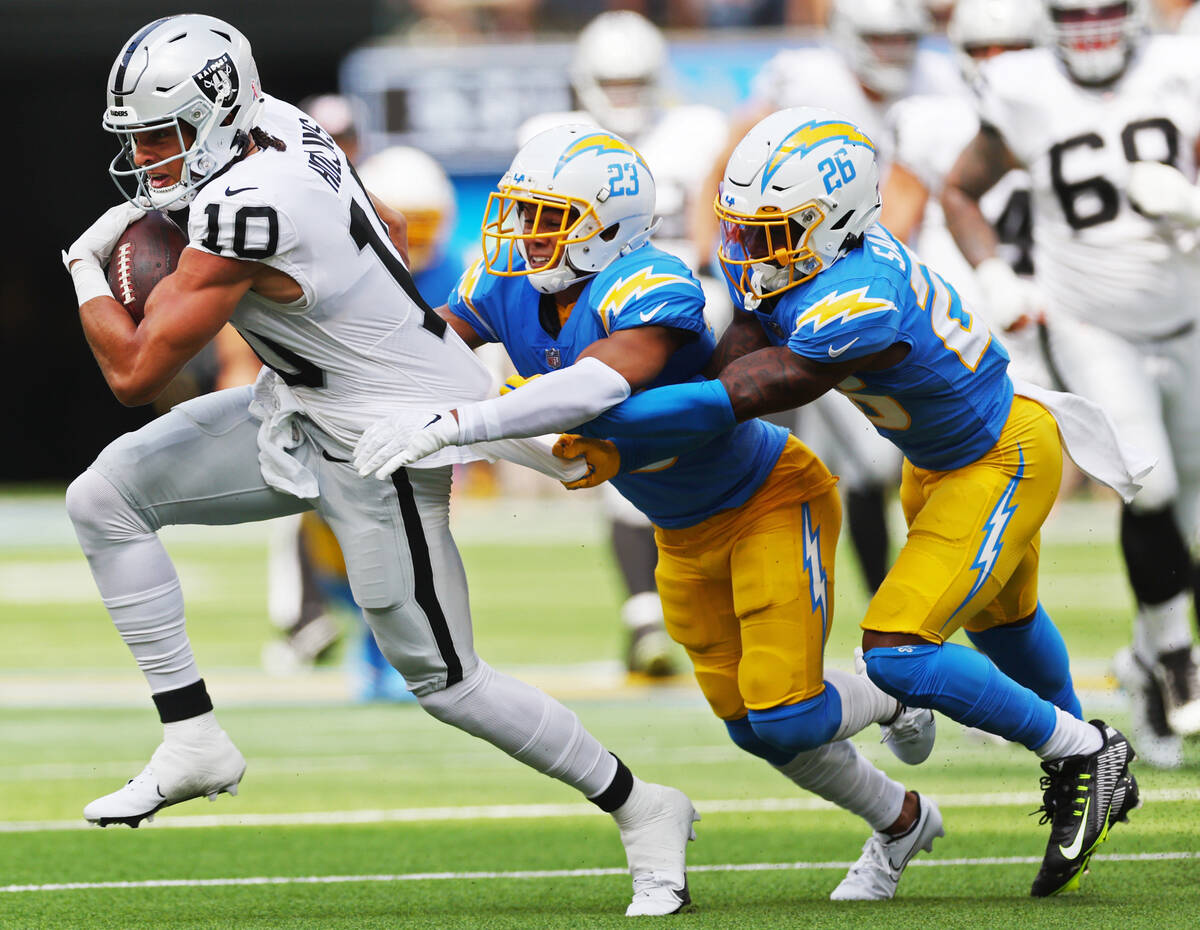 Raiders wide receiver Mack Hollins (10) runs the ball before getting tackled by Los Angeles Cha ...