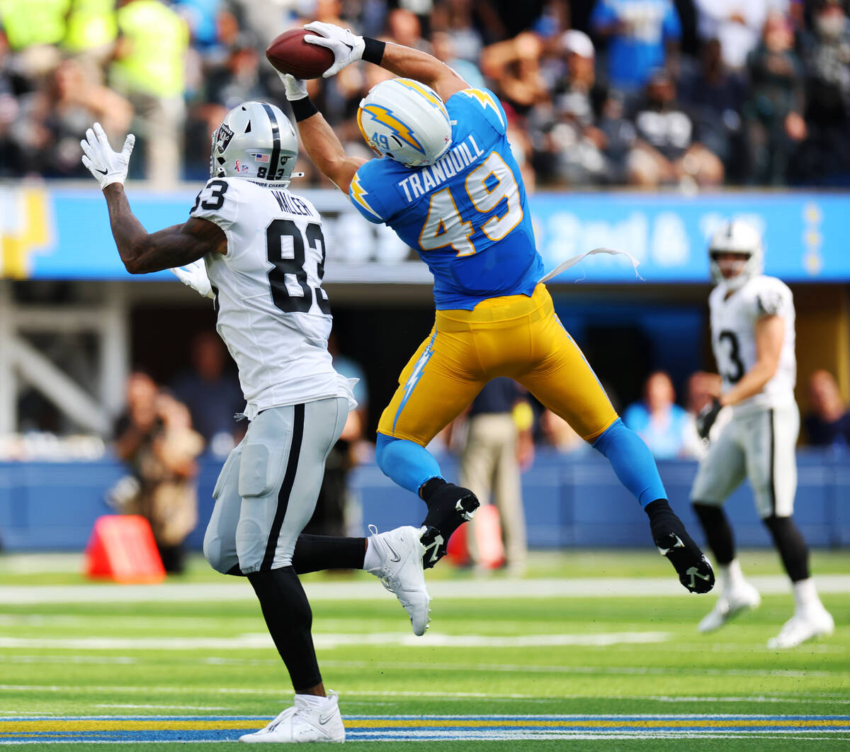 Los Angeles Chargers linebacker Drue Tranquill (49) intercepts a ball intended for Raiders tigh ...