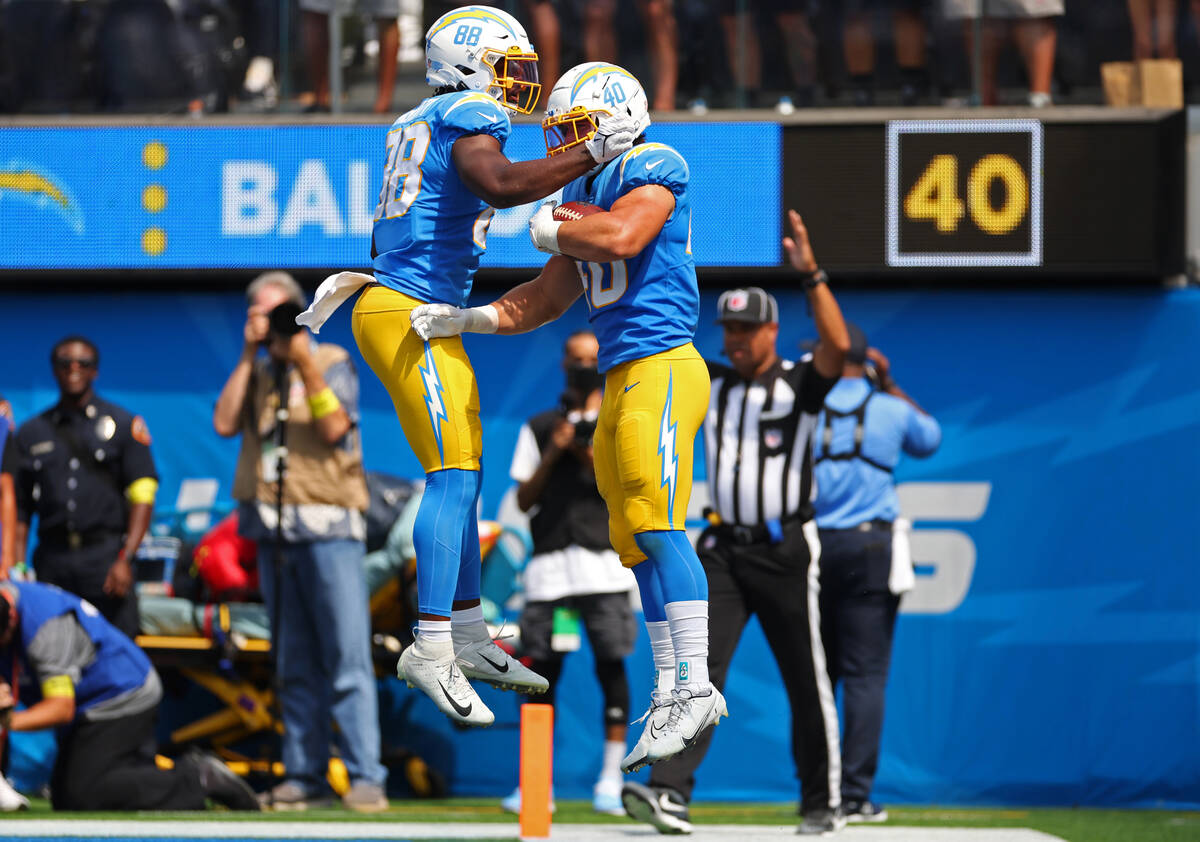 Los Angeles Chargers fullback Zander Horvath (40) celebrates his touchdown with tight end Tre' ...