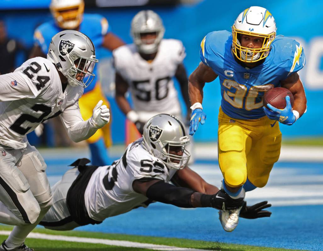 Raiders defensive end Chandler Jones (55) tackles Los Angeles Chargers running back Austin Ekel ...