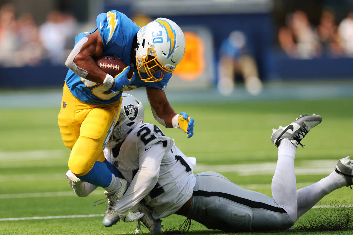 Raiders safety Johnathan Abram (24) tackles Los Angeles Chargers running back Austin Ekeler (30 ...