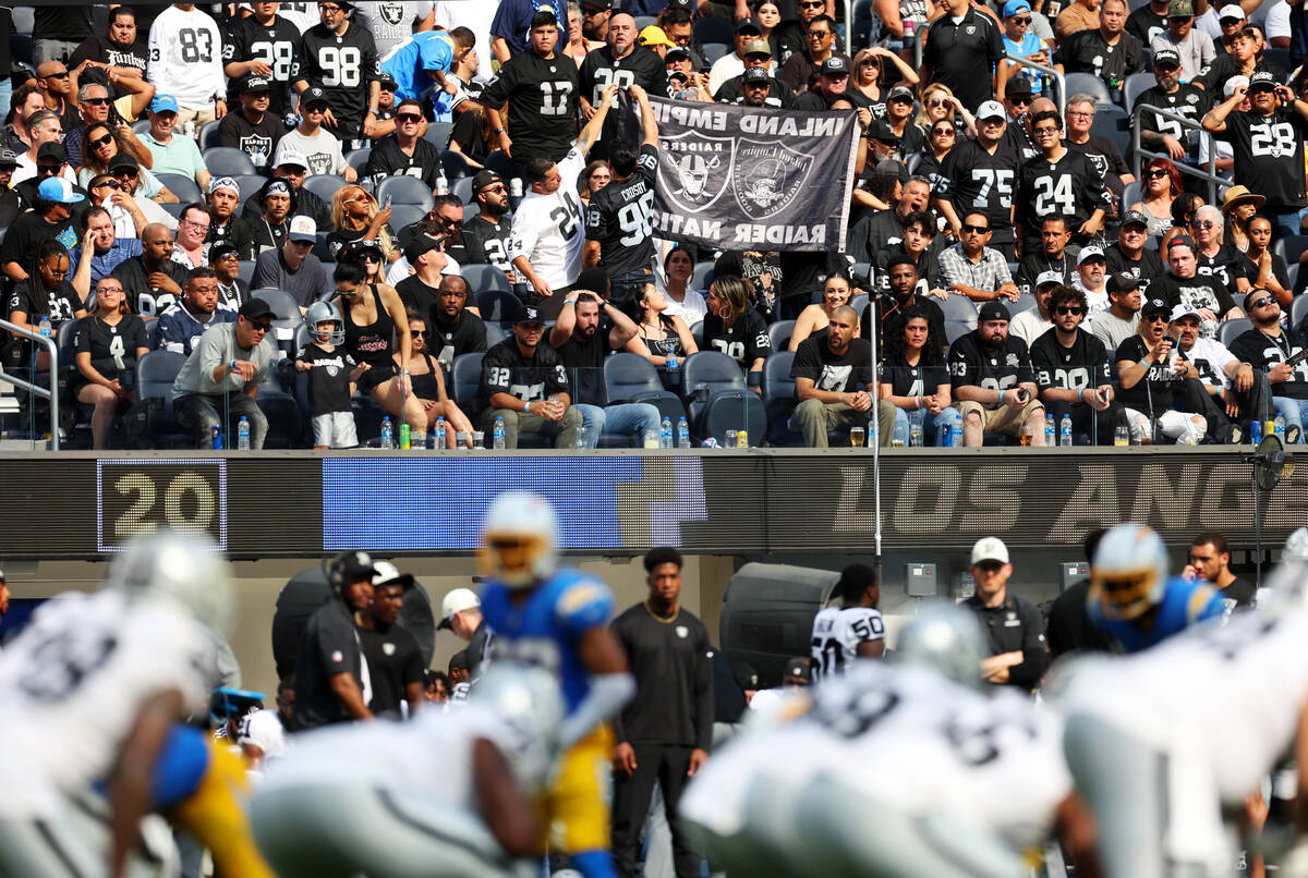 Fans watch the second half of a NFL football game between the Raiders and the Los Angeles Charg ...