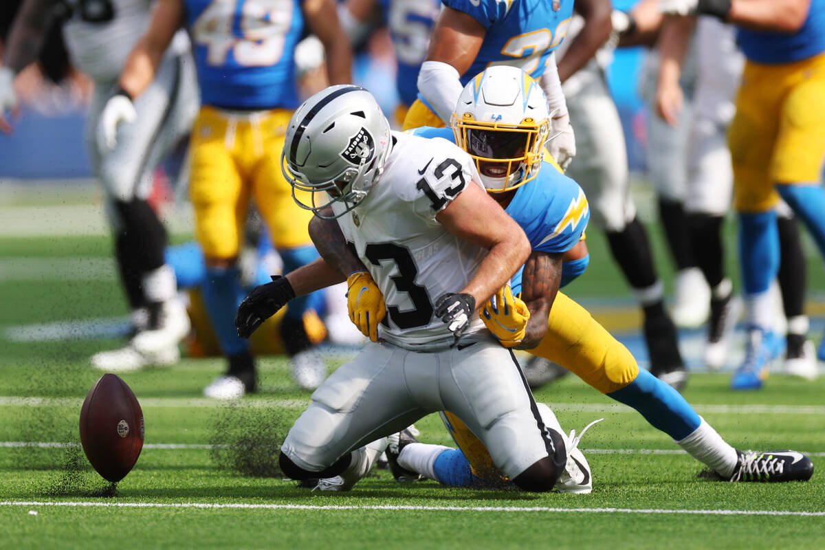 Los Angeles Chargers safety Nasir Adderley (24) forces Raiders wide receiver Hunter Renfrow (13 ...