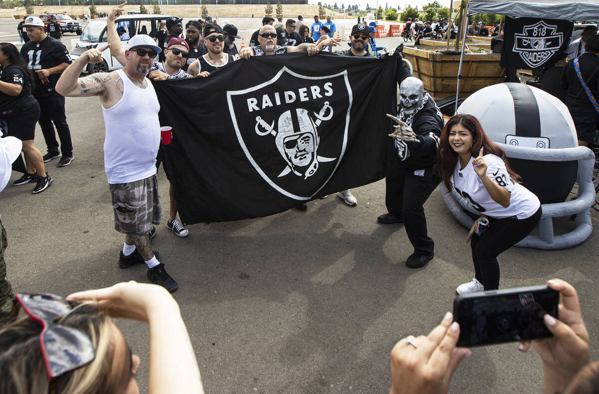 Raiders fans pose for photos before the start of an NFL game at SoFi Stadium on Sunday, Sept. 1 ...