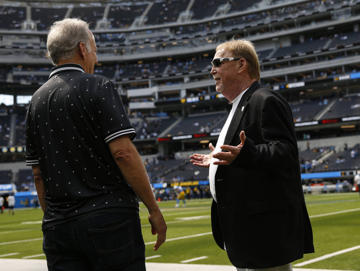 Raiders owner Mark Davis, right, talks with an unidentified man before the start of an NFL game ...