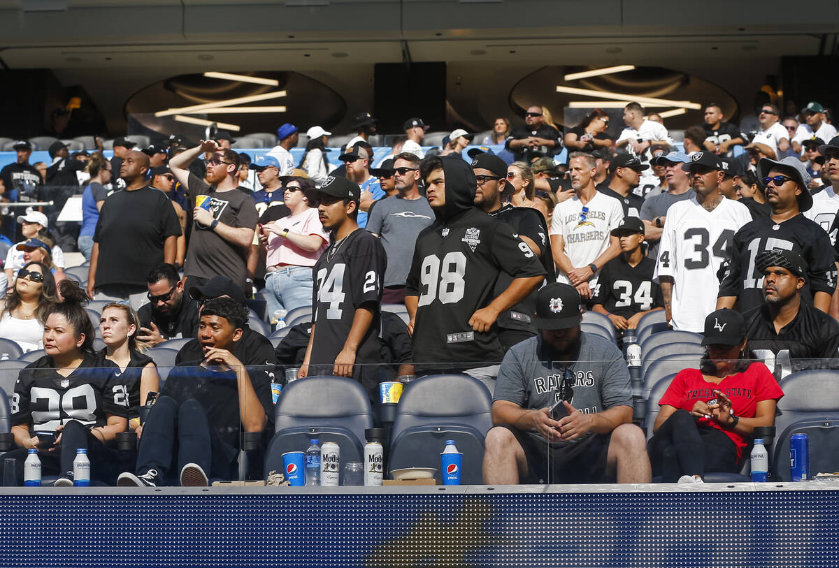 Raiders fans look on as their team trails against the Los Angeles Chargers during the second ha ...