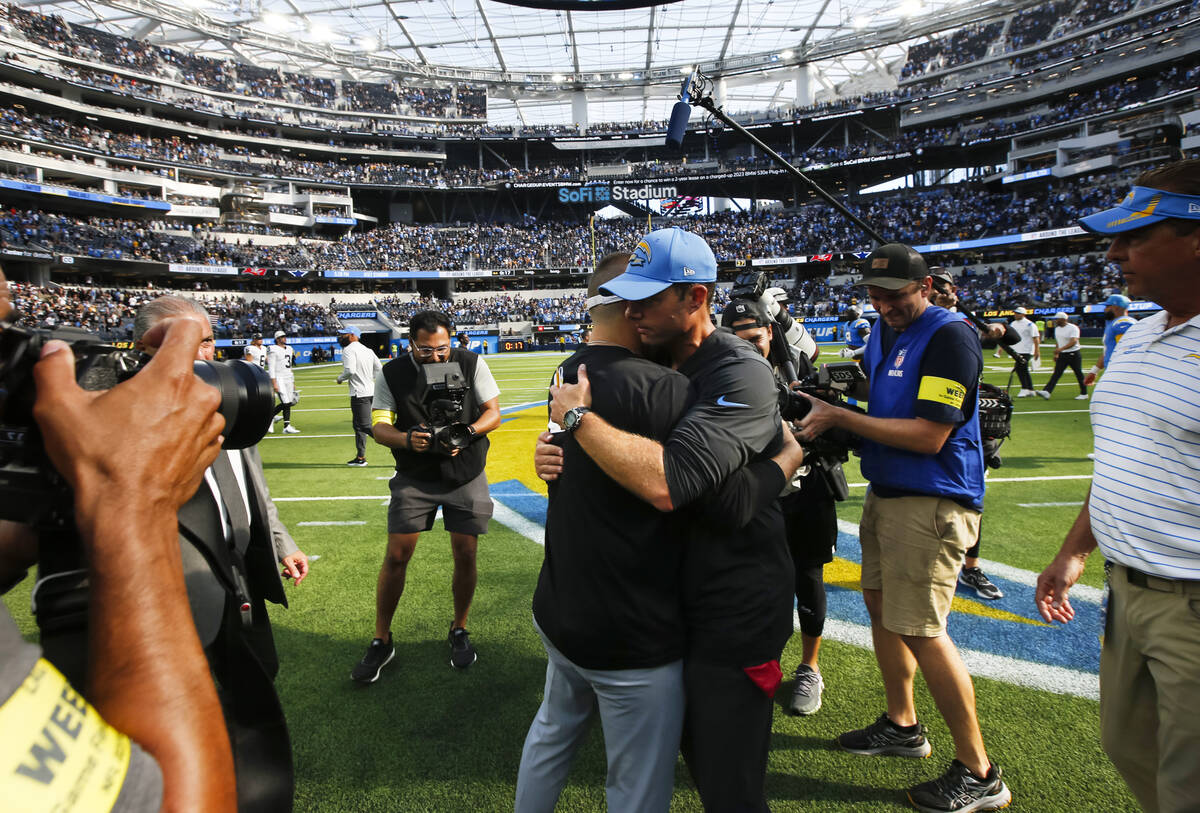 Raiders head coach Josh McDaniels, left, greets Los Angeles Chargers head coach Brandon Staley ...