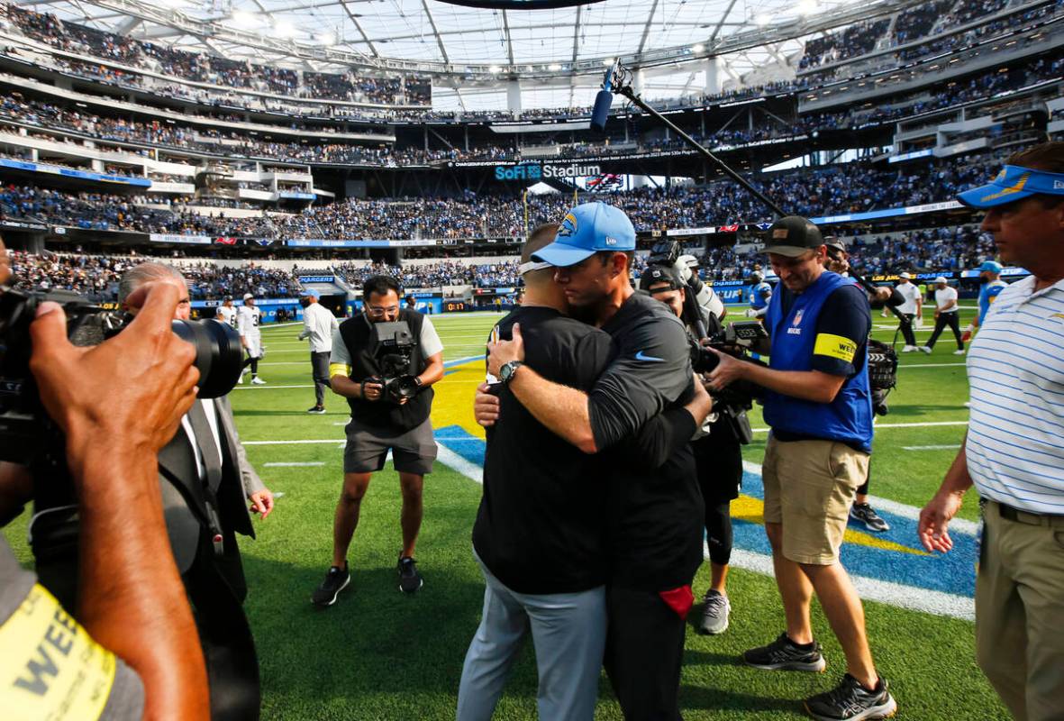 Raiders head coach Josh McDaniels, left, greets Los Angeles Chargers head coach Brandon Staley ...