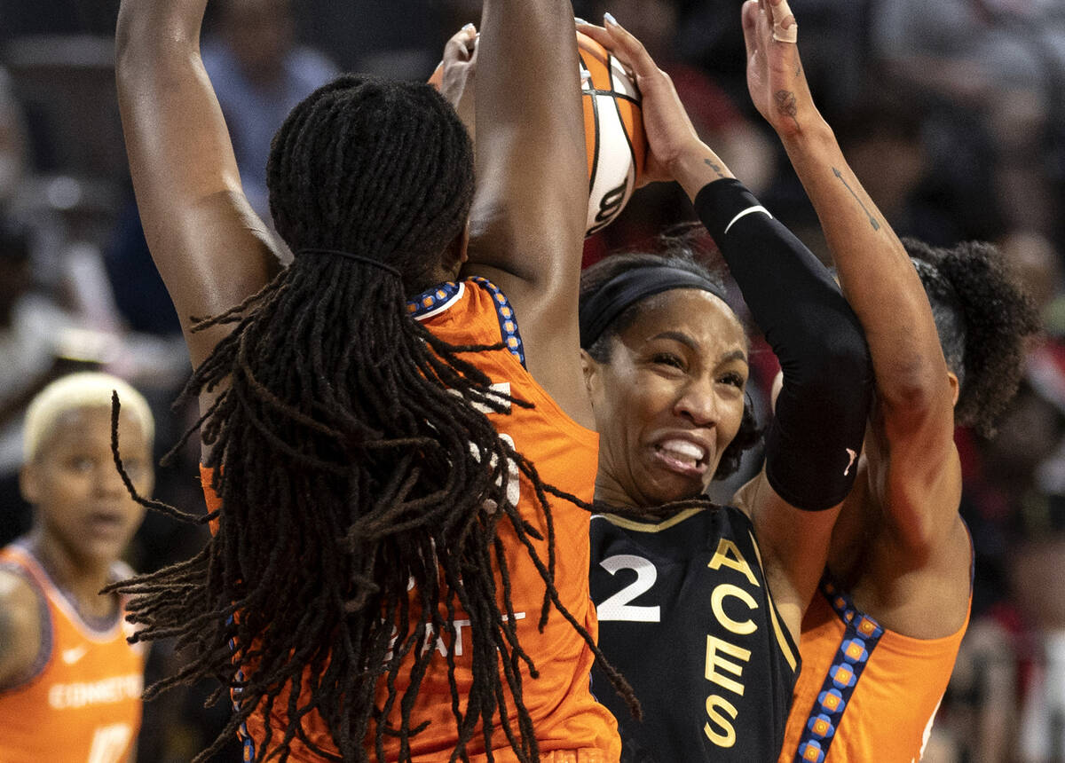 Las Vegas Aces forward A'ja Wilson (22) shoots against Connecticut Sun forward Jonquel Jones, l ...