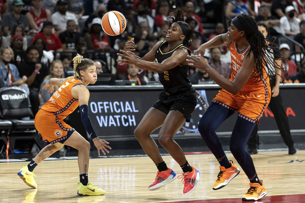 Las Vegas Aces guard Jackie Young (0) loses control of the ball while Connecticut Sun guard Nat ...